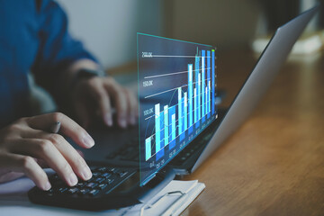 Businessman planning and business growth on desk with virtual screen. Calculate income and profit on investments and an increase in the indicators of positive growth.