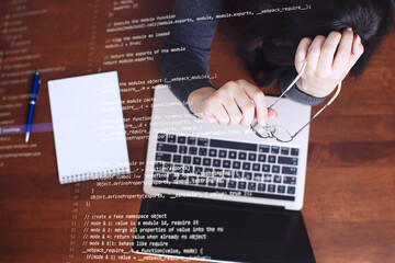 Programmer working on laptop computer and coding code on screen. Internet and technology concept.