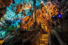 Illuminated Natural Underground Rock Formations Inside St. Michaels Cave In Gibraltar, UK