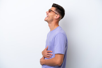 Sticker - Young caucasian man isolated on white background laughing in lateral position