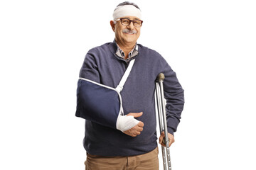 Wall Mural - Mature man with a broken arm and bandage on head leaning on a crutch