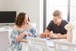© Austockphoto - Male NDIS provider assisting young woman with down syndrome using tablet