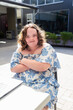 © Austockphoto - Portrait of female teenager with down syndrome working at cafe table with laptop