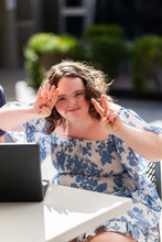 Portrait Of Teen Girl With Down Syndrome Making Peace Sign