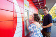 © Austockphoto - Young person with a disability using post office lock box in town