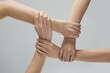 © Natalie Portman/Wirestock Creators - Closeup shot of helping hands touching in front of a gray background