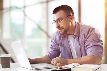 Poster - young business male working on computer