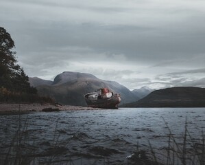 Sticker - Old abandoned ship on the coast in Fort William town in Scotland surrounded by hills