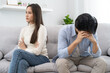 © Pormezz - Family problems, Asian women cover her face and sit separately from husband feel disappointed after quarrels at home.