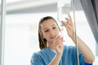 © NINENII - Doctor nurse wear checking saline bag for patient at hospital room. Physician man care drip fluid saline bottle. Health care concept.