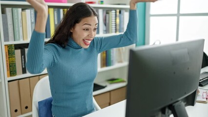 Sticker - Young beautiful hispanic woman student using computer with winner expression at university classroom