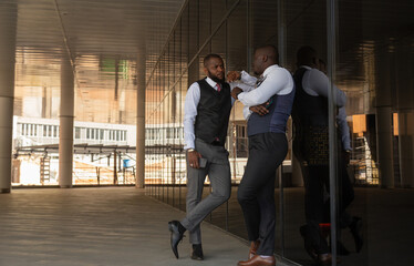 Sticker - Portrait of two handsome african american businessman partner friends in suit against modern building exterior