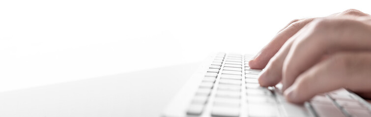 Poster - male hands on a white keyboard on a white background. Business concept