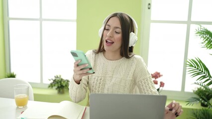 Sticker - Young beautiful hispanic woman student smiling confident listening to music at home