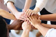 © MVProductions - Many hands from diverse people joining together in circle, people putting hands together as symbol of unity. High quality generative ai