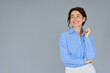© insta_photos - Happy young smiling professional business woman wearing blue shirt looking away interested in ads at copy space presenting advertising promotion standing isolated at gray background.