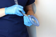 Laryngeal mask airway (LMA) in a health care professional wearing surgical gloves and surgical scrubs