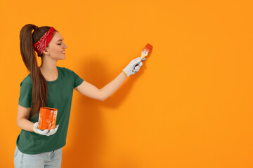 Canvas Print - Designer painting orange wall with brush, space for text