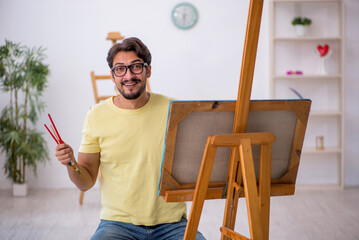 Wall Mural - Young man enjoying painting at home