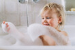 © Cavan Images - Girl baby blonde bathes at home in the bathroom