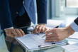 © ty - Business adviser analyzing financial figures denoting the progress in the work of the company.