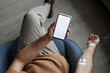 © Seventyfour - Top view of man using smartphone with white screen mockup during IV drip treatment, copy space