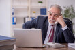 © Elnur - Old male employee and too much work in the office
