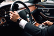 © Nadia - a man in a suit driving a car with his hands on the steering wheel.  generative ai
