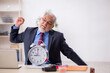 © Elnur - Old male employee in time management concept