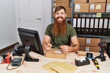 Poster - Young redhead man business worker prepare order package at office