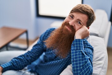 Canvas Print - Young redhead man smiling confident sitting on sofa at home