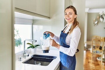 Poster - Young blonde woman smiling confident washing jar at kitchen