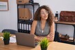 © Krakenimages.com - Young beautiful hispanic woman business worker sitting with arms crossed gesture at office