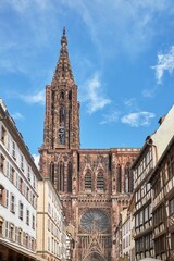 Sticker - Vertical low angle shot of the historic Strasbourg Cathedral exterior against a blue sky in France