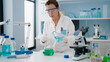 © Krakenimages.com - Middle age hispanic woman wearing scientist uniform pouring liquid on test tube at laboratory