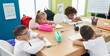 © Krakenimages.com - Group of kids students sitting on table studying at classroom