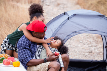 happy african american family, father and children travel and camping tent trip in nature relax summer camp, summertime active vacation. happy holiday.