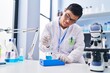 © Krakenimages.com - Down syndrome man wearing scientist uniform measuring liquid at laboratory