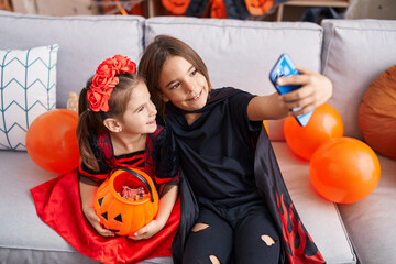 Poster - Adorable boy and girl wearing halloween costume make selfie by smartphone at home