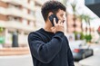 © Krakenimages.com - Young arab man smiling confident talking on the smartphone at street