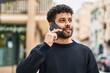 © Krakenimages.com - Young arab man smiling confident talking on the smartphone at street