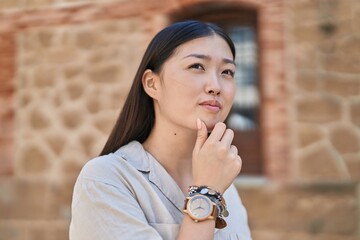 Sticker - Chinese woman standing with doubt expression at street