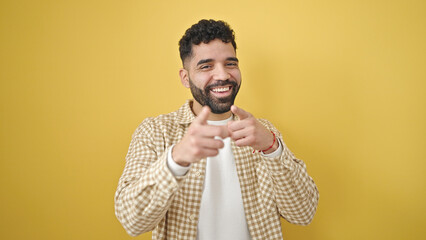 Poster - Young hispanic man smiling confident pointing with fingers to the camera over isolated yellow background