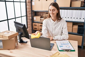 Sticker - Young caucasian woman ecommerce business worker cleaning laptop at office