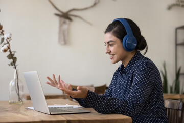 Poster - Smiling Indian woman in headphones use laptop make video call, talks to client, lead videocall by business or study, e-learns, share knowledge to learner. Tuition, virtual meeting, on-line counselling