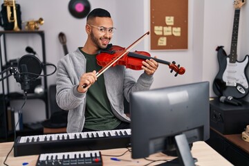 Sticker - African american man musician smiling confident playing violin at music studio