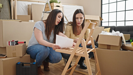 Two women repairing chair at new home