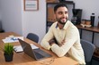 © Krakenimages.com - Young arab man business worker using laptop sitting on arms crossed gesture at office