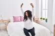 © Krakenimages.com - African american woman waking up stretching arms at bedroom