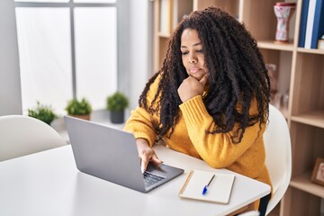 Poster - African american woman using laptop sitting on table at home